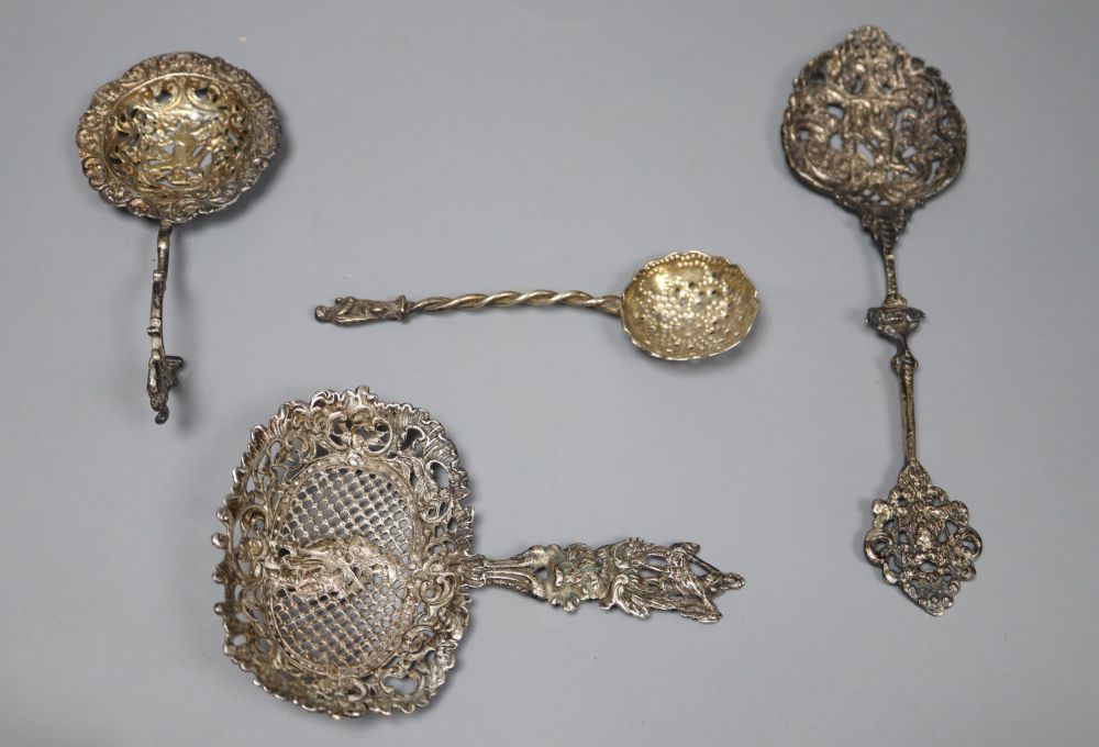 A Dutch oval silver tea caddy, embossed with cherubs and scrolls, 1893 import marks and four sifter spoons, various 5.5oz (caddy)